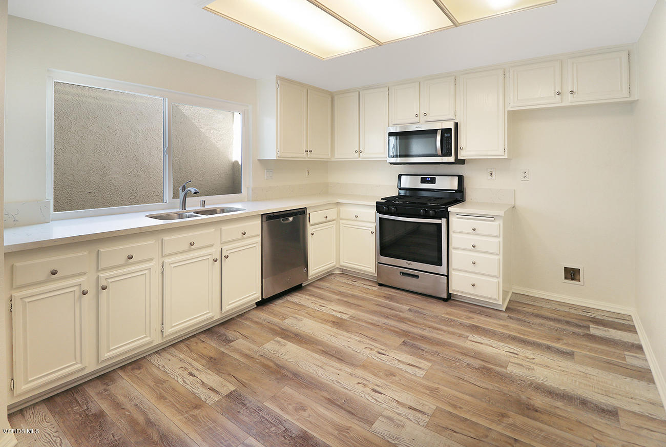 851 Congressional Road Simi Valley, CA 93065 - Photo 10 of 28 a kitchen with stainless steel appliances granite countertop a stove a sink and a microwave