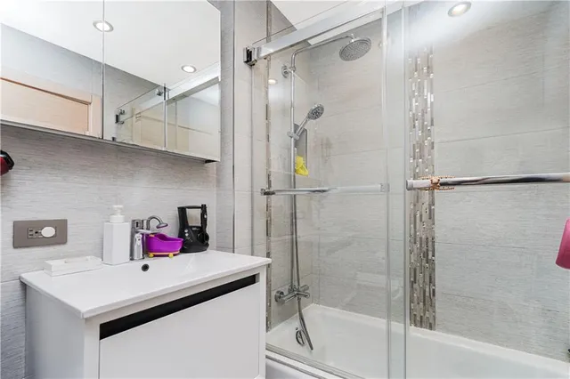 a bathroom with a shower and a sink