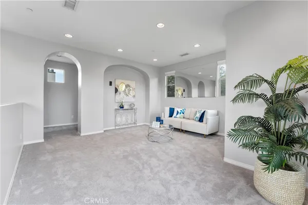 a living room with furniture and a potted plant