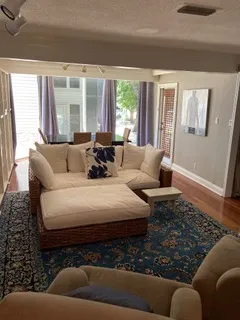 a living room with furniture and a painting on the wall