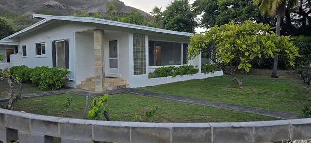 a front view of a house with garden