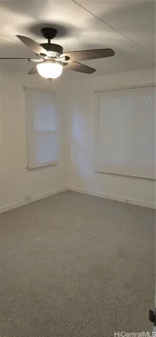 a view of a house with backyard and a large tree