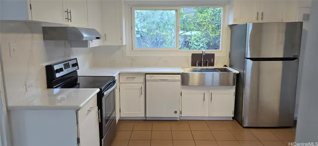 a kitchen with a stove a refrigerator and a sink