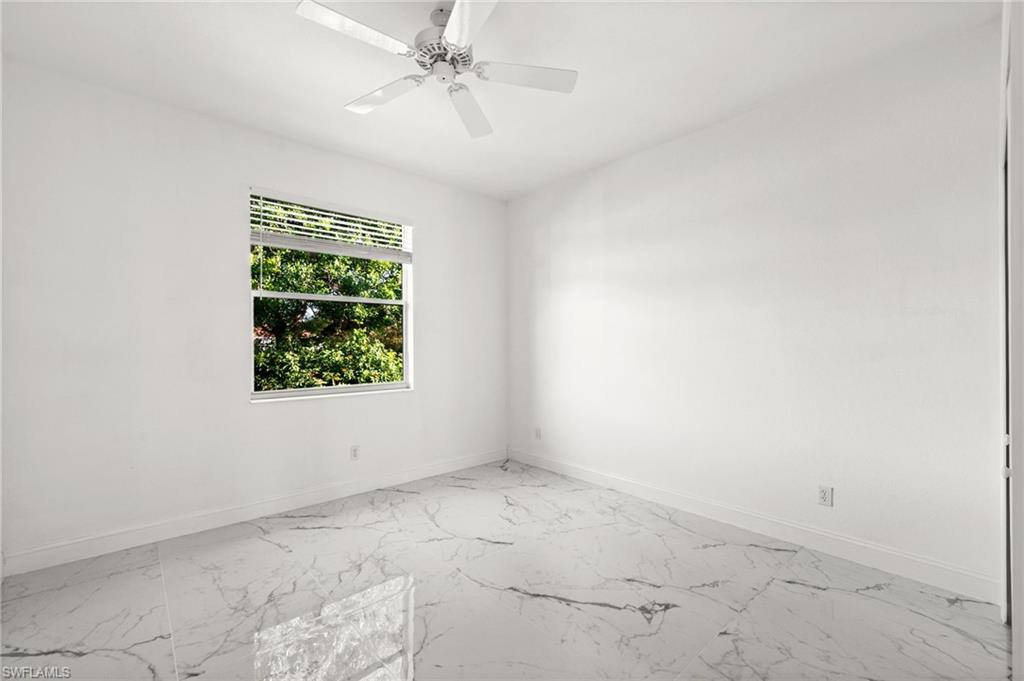3972 Ruxton Road Naples, FL 34116 - Photo 30 of 41 an empty room with windows and fan