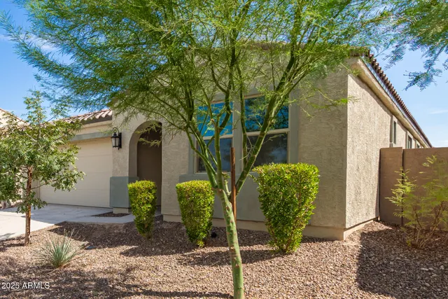 a front view of a house with garden