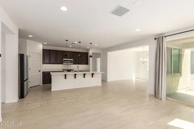 an empty room with a window and wooden floor