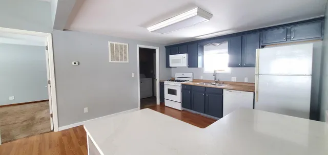 a kitchen with a refrigerator and a sink