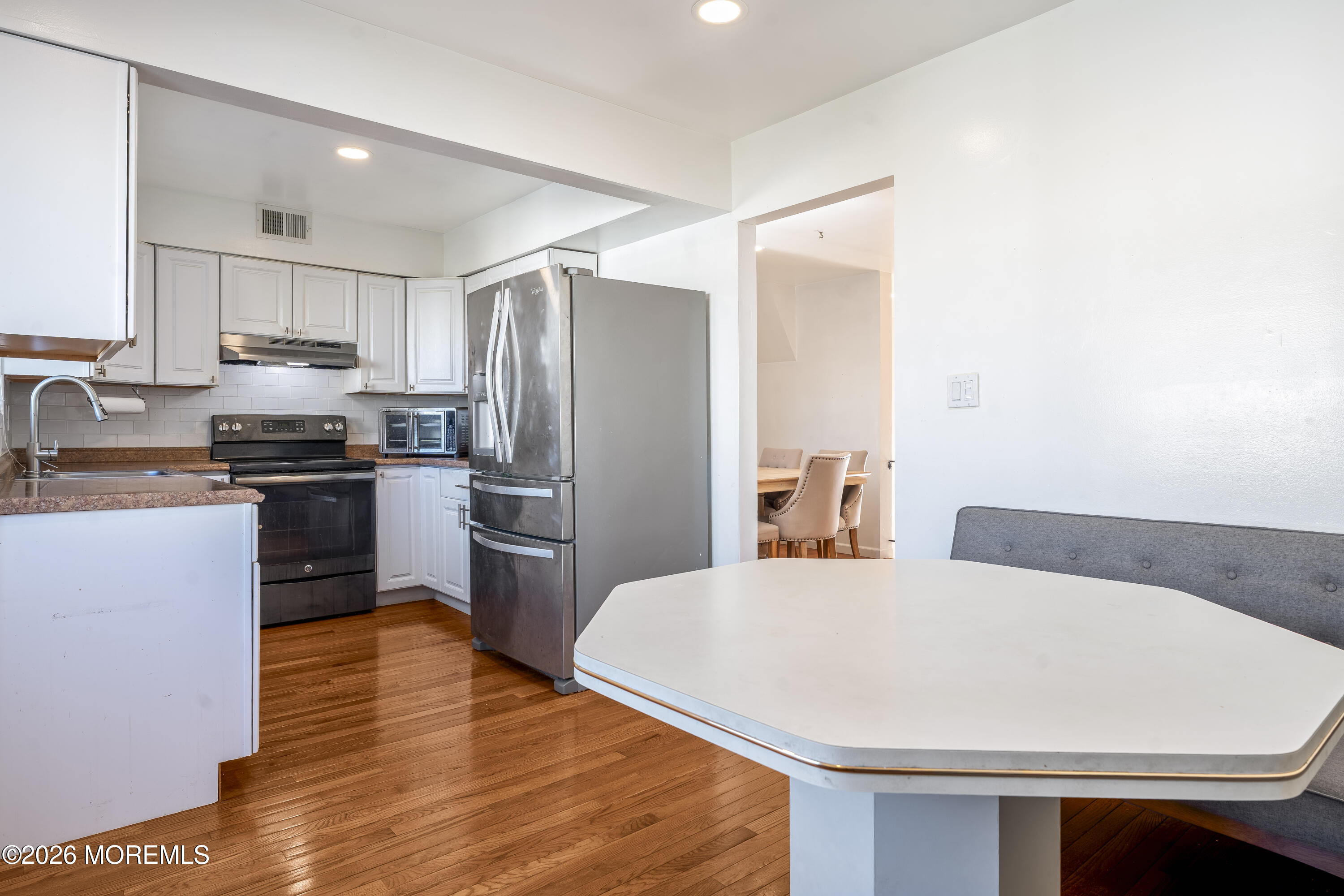424 Middlewood Road Middletown, NJ 07748 - Photo 4 of 22 a kitchen with stainless steel appliances a refrigerator a stove a sink dishwasher and a oven with wooden floor