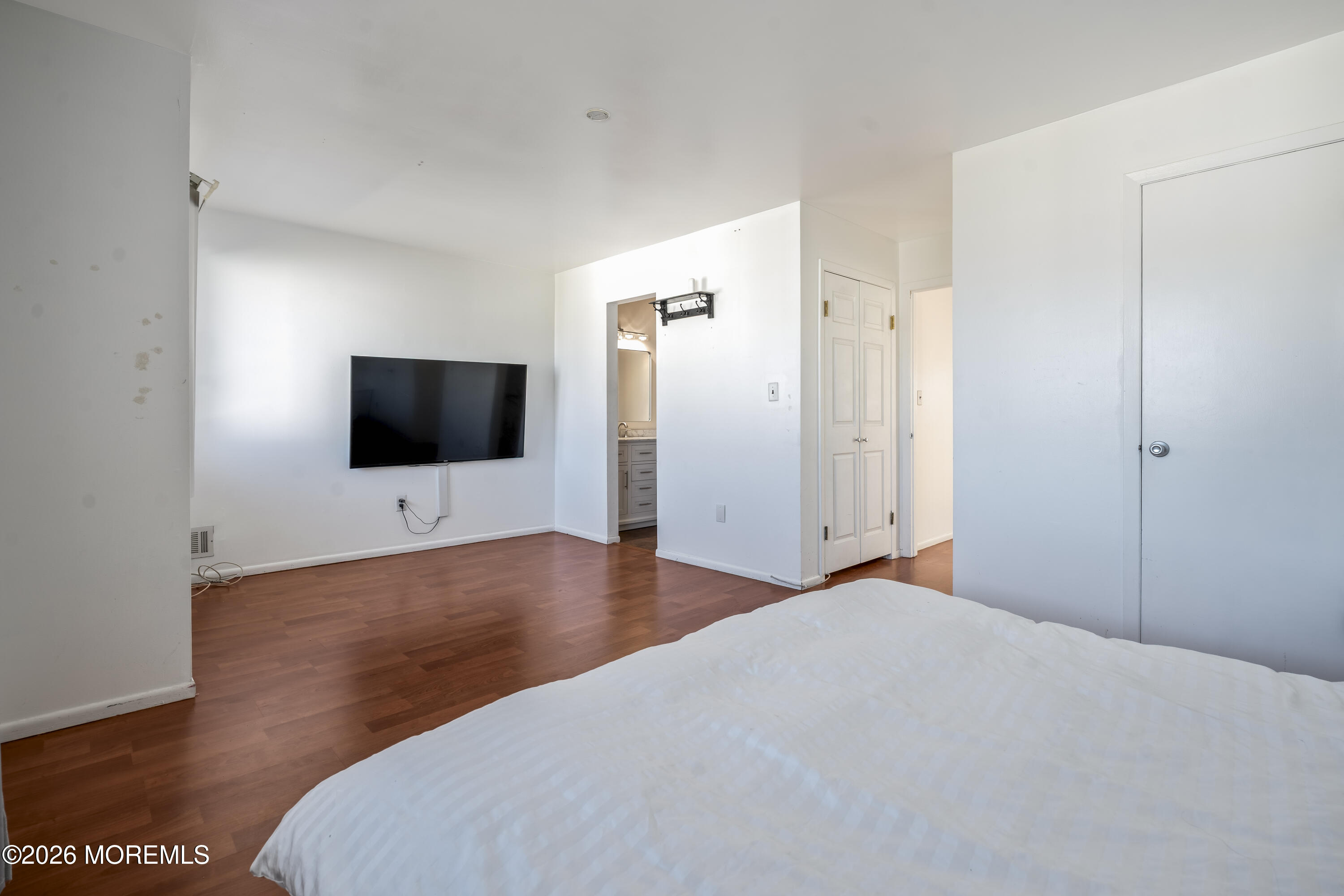 424 Middlewood Road Middletown, NJ 07748 - Photo 8 of 22 a bedroom with a bed and a flat screen tv