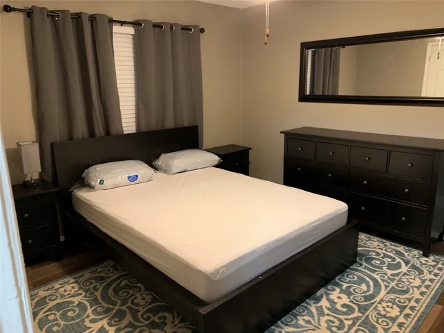 a bedroom with a bed and a dresser