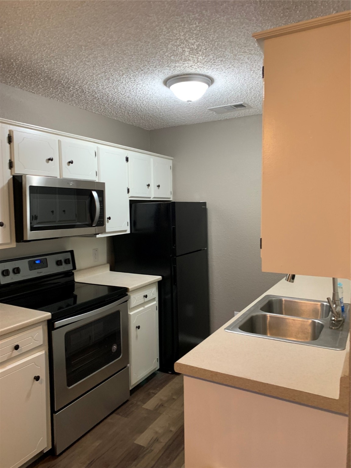 1601 Meadowview Drive Port Lavaca, TX 77979 - Photo 26 of 38 a kitchen with white cabinets and stainless steel appliances