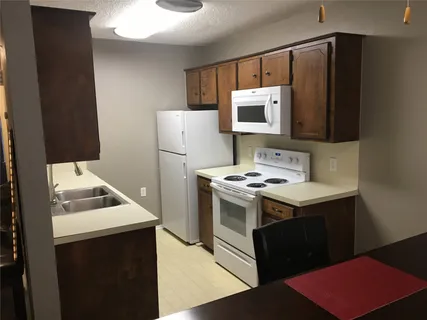 a kitchen with a sink stove and refrigerator
