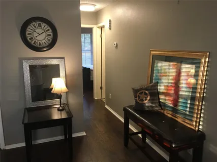 a room with a table lamp and a view of a livingroom