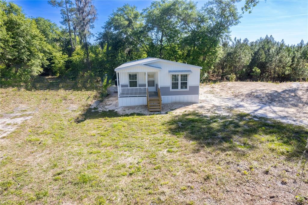 15049 Southwest 75th Avenue Starke, FL 32091 - Photo 1 of 1 a front view of a house with a yard