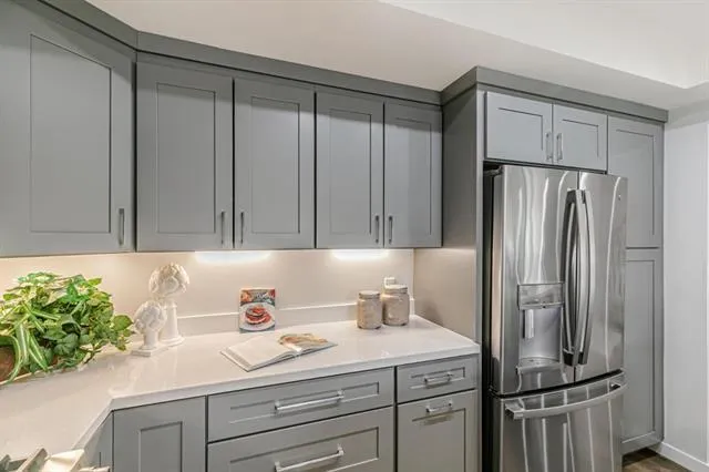 a kitchen with a refrigerator and a sink