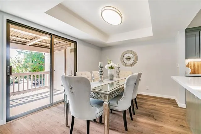 a dining room with furniture a rug and a large window