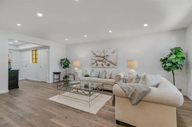 a living room with furniture potted plant and a window