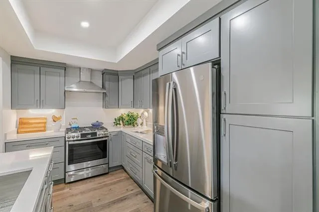 a kitchen with stainless steel appliances a refrigerator and a stove