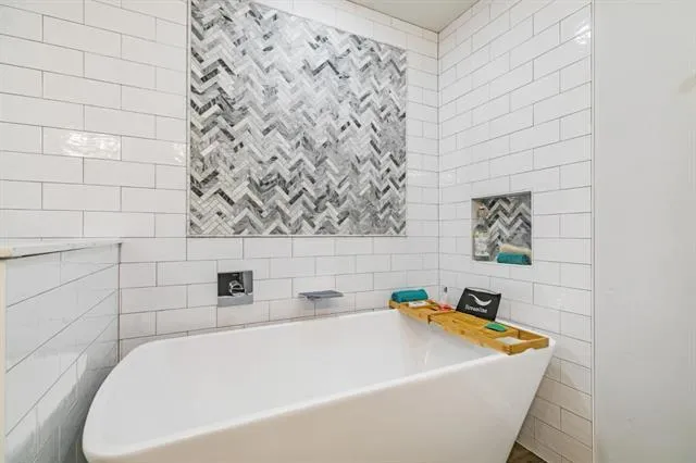 a spacious bedroom with a bed and a window