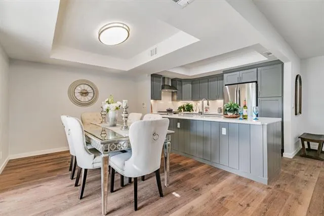 a dining room with wooden floor and window