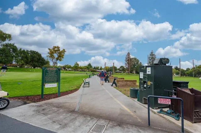 a view of a park with iron fence
