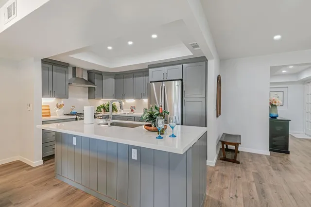 a kitchen with sink refrigerator and cabinets