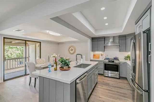a kitchen with granite countertop a refrigerator and a stove