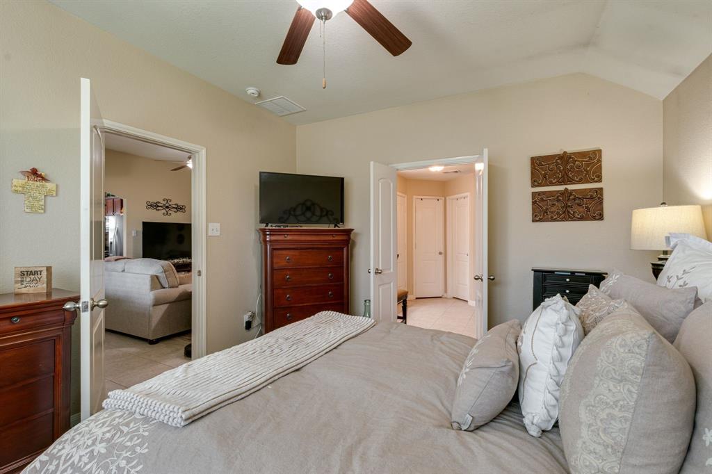 1853 Olive Lane Anna, TX 75409 - Photo 10 of 23 Bedroom featuring a ceiling fan, vaulted ceiling, stainless steel fridge with ice dispenser, and light tile patterned floors