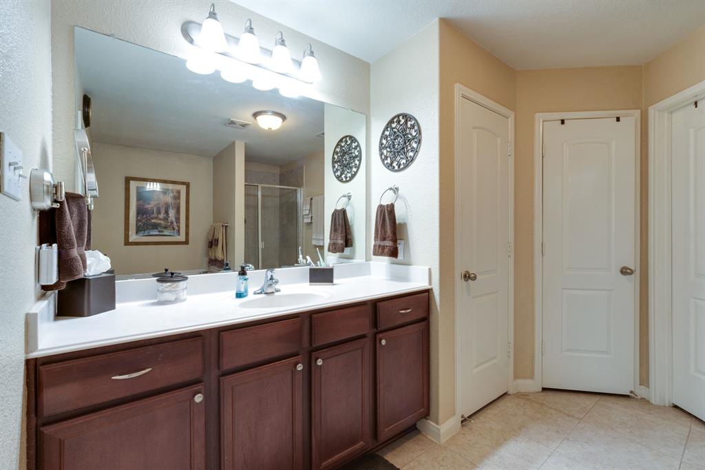 1853 Olive Lane Anna, TX 75409 - Photo 11 of 23 Bathroom with vanity, a stall shower, light tile patterned flooring, and a closet