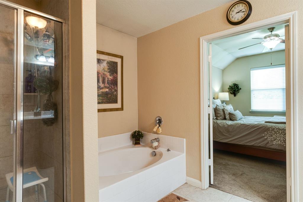 1853 Olive Lane Anna, TX 75409 - Photo 12 of 23 Full bathroom featuring ensuite bathroom, a stall shower, a ceiling fan, a bath, and vaulted ceiling
