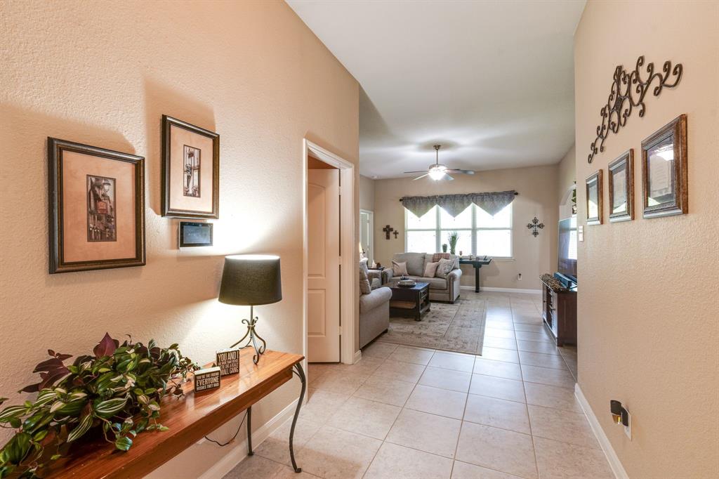 1853 Olive Lane Anna, TX 75409 - Photo 3 of 23 Corridor featuring a textured wall and light tile patterned flooring