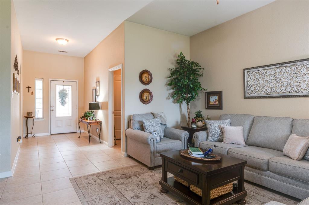 1853 Olive Lane Anna, TX 75409 - Photo 7 of 23 Living room featuring light tile patterned floors and baseboards