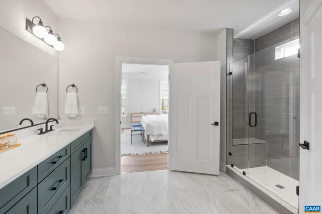a spacious bathroom with a shower sink and mirror