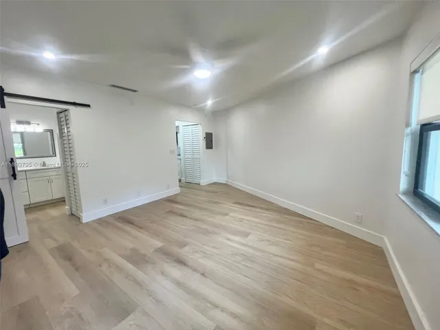 a view of a room with wooden floor