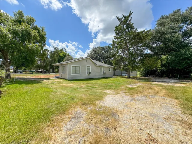 a house view with swimming pool in front of it