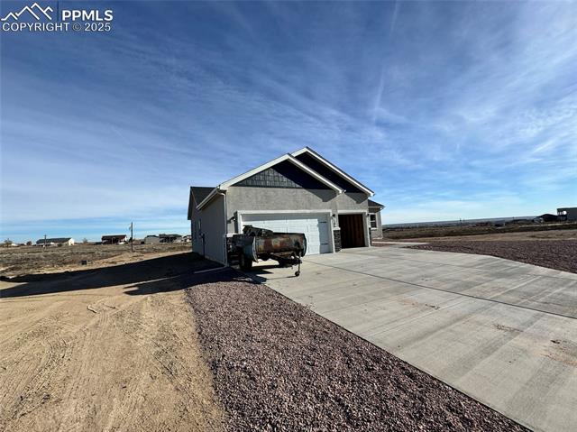 3955 Yoder Road Yoder, CO 80864 - Photo 2 of 27 View of side of property featuring a garage