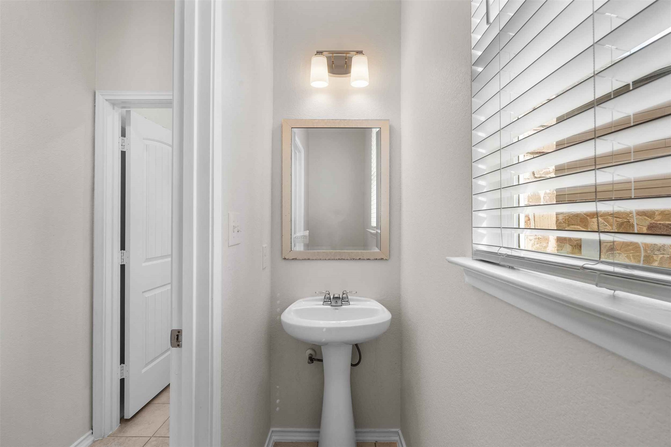116 Kyndals Meadow Cove Georgetown, TX 78628 - Photo 12 of 36 a bathroom with a sink a mirror and a window