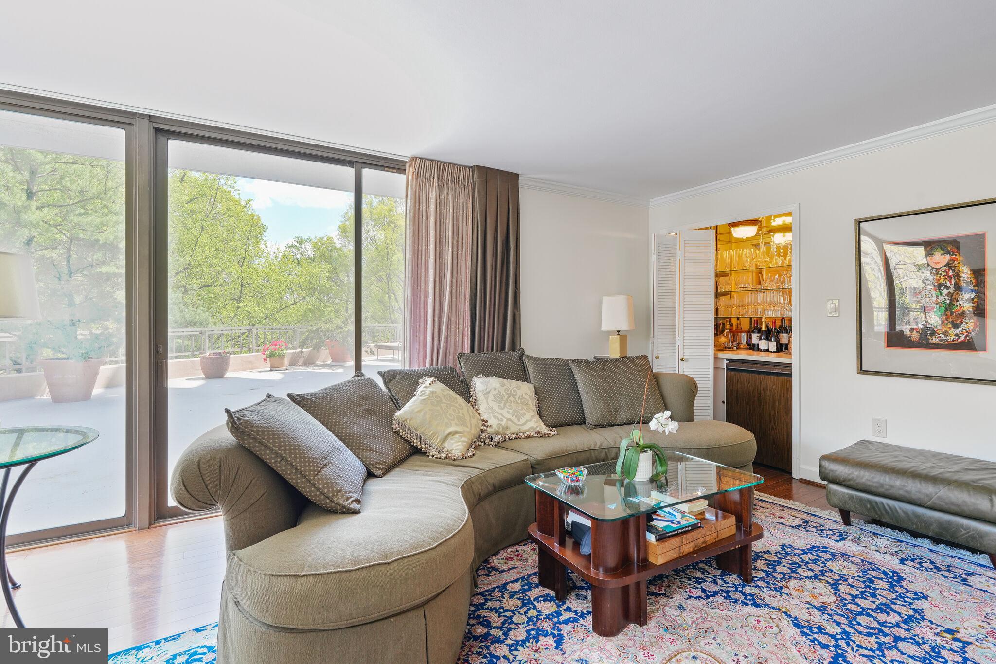 4200 Massachusetts Avenue Northwest, Unit 106 Washington, DC 20016 - Photo 11 of 48 a living room with furniture and a large window