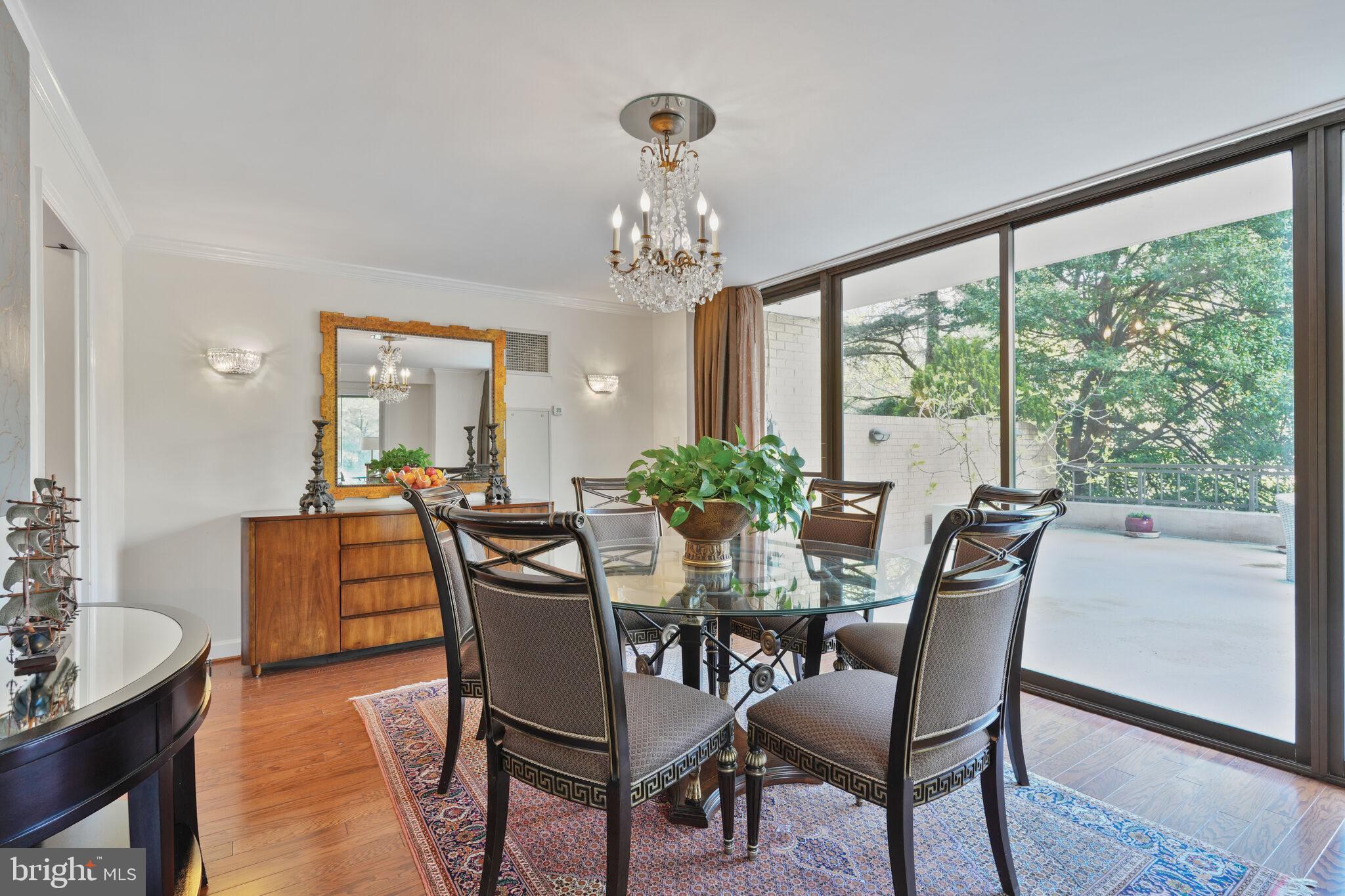 4200 Massachusetts Avenue Northwest, Unit 106 Washington, DC 20016 - Photo 12 of 48 a dining room with furniture a large window and wooden floor