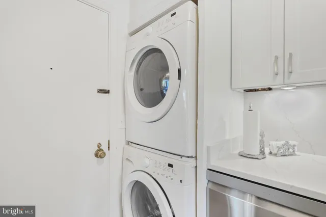 a close view of a utility room with dryer and washer