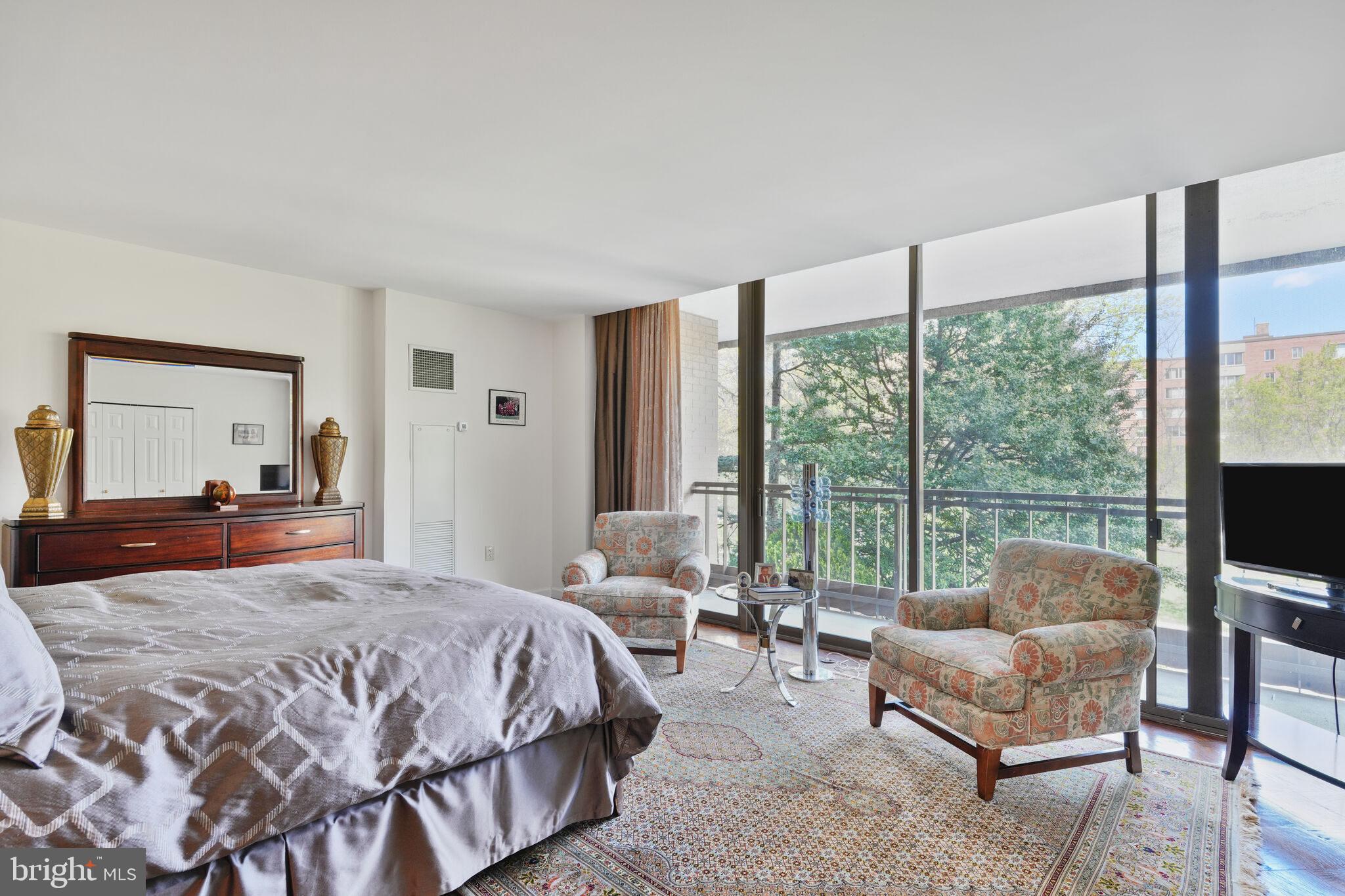4200 Massachusetts Avenue Northwest, Unit 106 Washington, DC 20016 - Photo 20 of 48 a bedroom with a bed and glass window