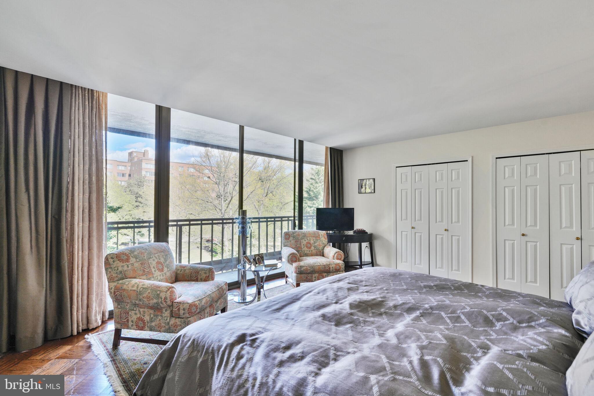 4200 Massachusetts Avenue Northwest, Unit 106 Washington, DC 20016 - Photo 21 of 48 a bedroom with furniture and large windows