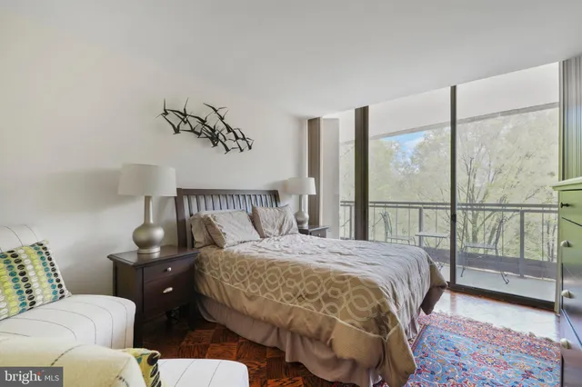 a bedroom with a bed and glass window