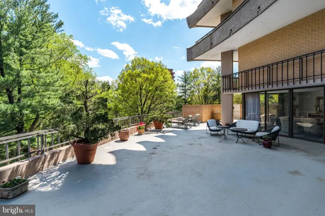 a view of a patio with a table and chairs and potted plants