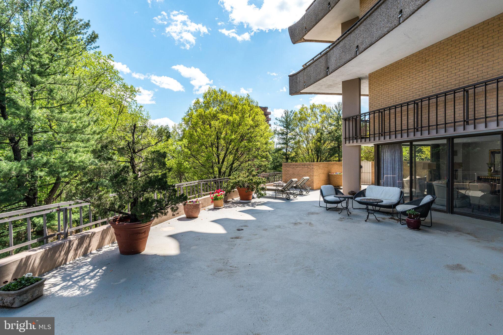 4200 Massachusetts Avenue Northwest, Unit 106 Washington, DC 20016 - Photo 36 of 48 a view of a patio with a table and chairs and potted plants