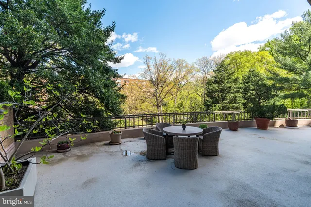 a view of a patio with a table and chairs