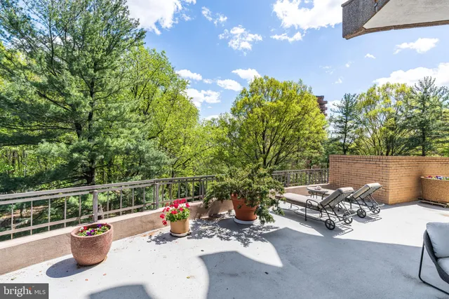 a view of a patio with iron fence