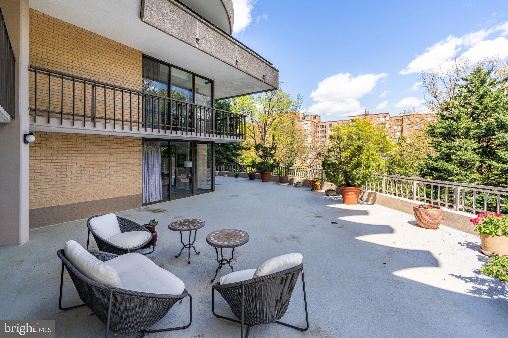 4200 Massachusetts Avenue Northwest, Unit 106 Washington, DC 20016 - Photo 39 of 48 a view of a patio with couches table and chairs and potted plants