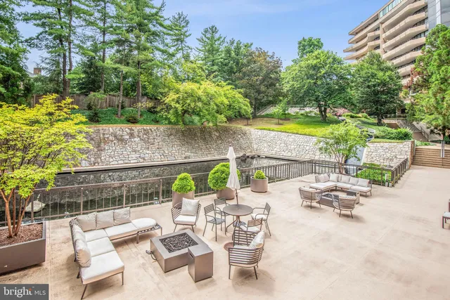 an outdoor sitting area with furniture and garden