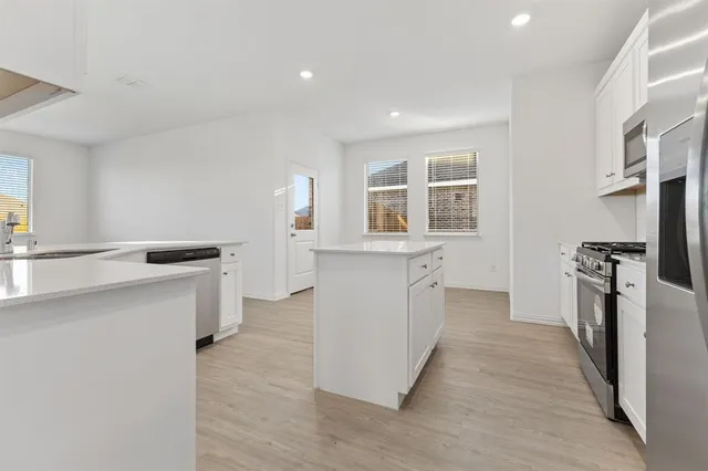 a kitchen with a refrigerator and a sink